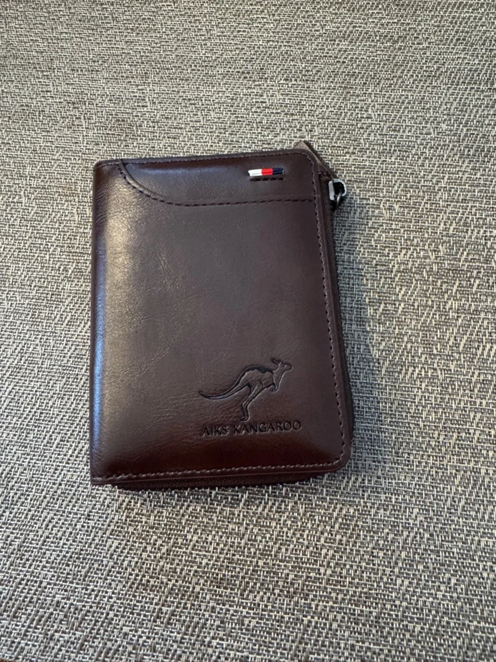 Men’s zip leather wallet in brown.‎
